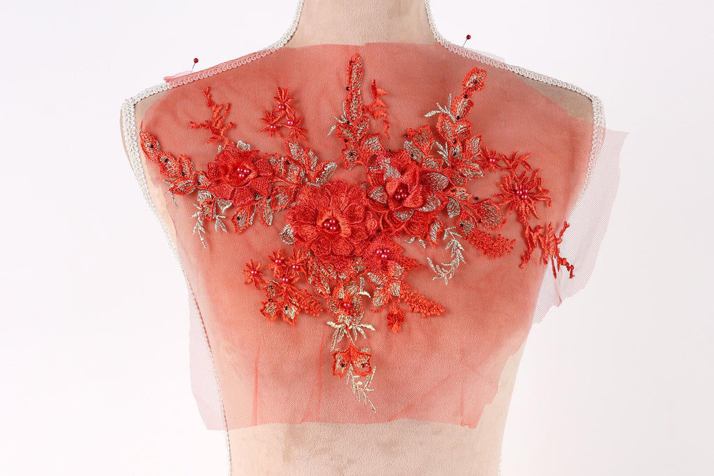 a mannequin with a red floral design on its back.