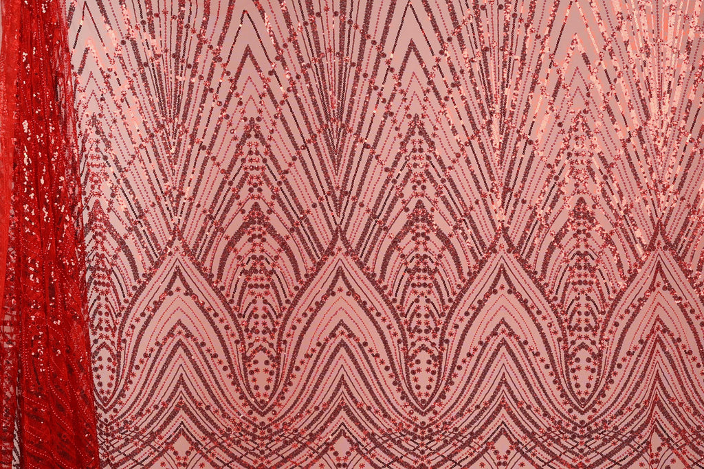 a close-up view of a fabric with a repeating pattern of red and pink sequin designs. The pattern consists of a series of diamond shapes and lines, creating a visually striking and intricate design. The fabric appears to be a sheer material, with the sequins adding a touch of sparkle and texture to the overall appearance.