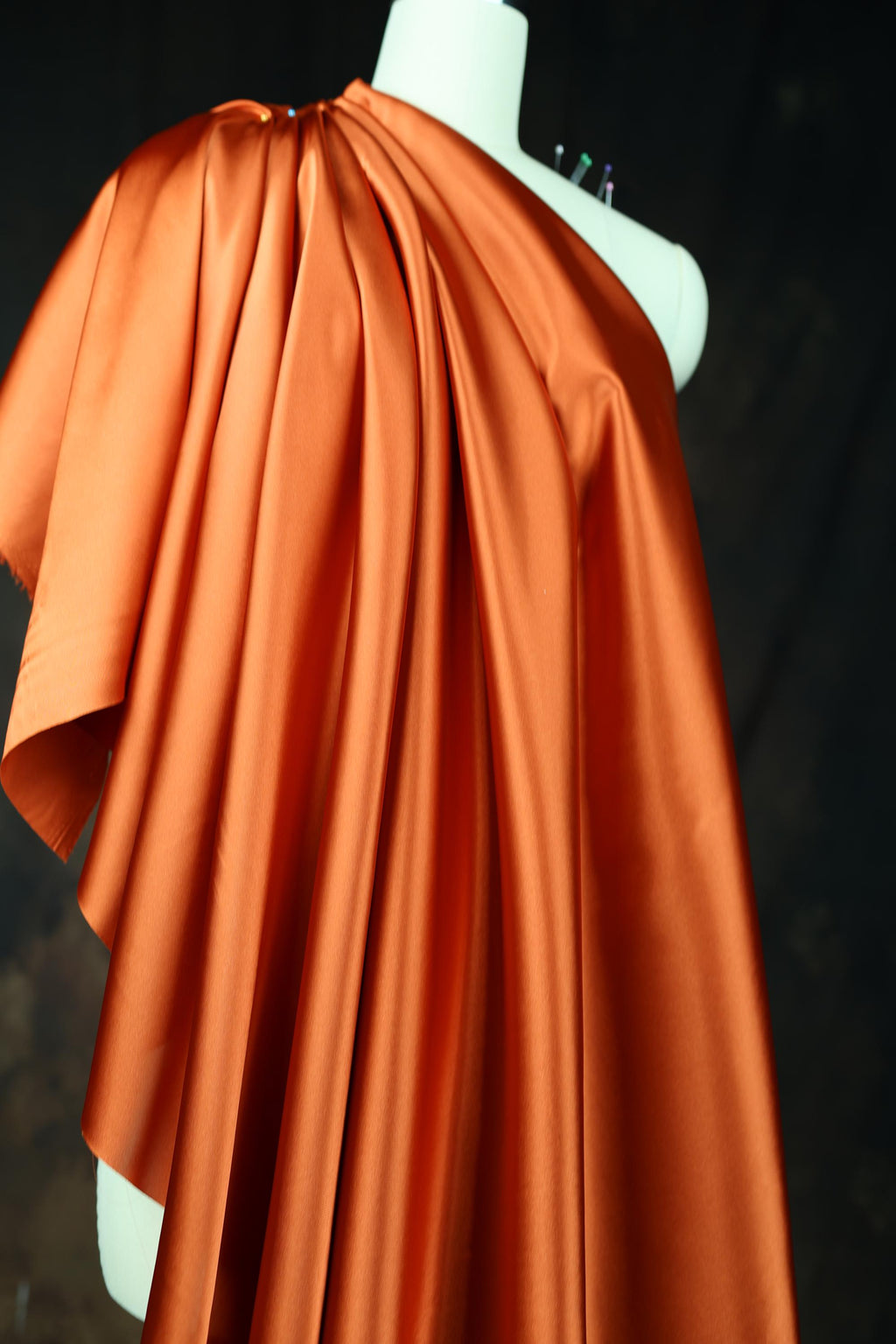 an orange cape on a mannequin head