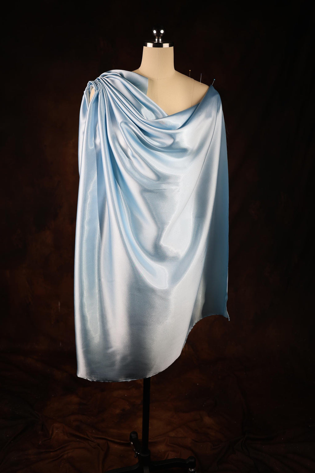 a mannequin wearing a light blue shawl