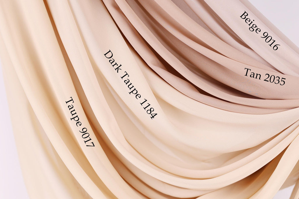 a close-up view of a fabric with different shades of beige, ranging from light to dark. The fabric appears to be a sheer or sheer-like material, with the colors appearing to be a light tan, a darker tan, and a darker tan. The image does not contain any text, and the focus is on the fabric and its color variations.