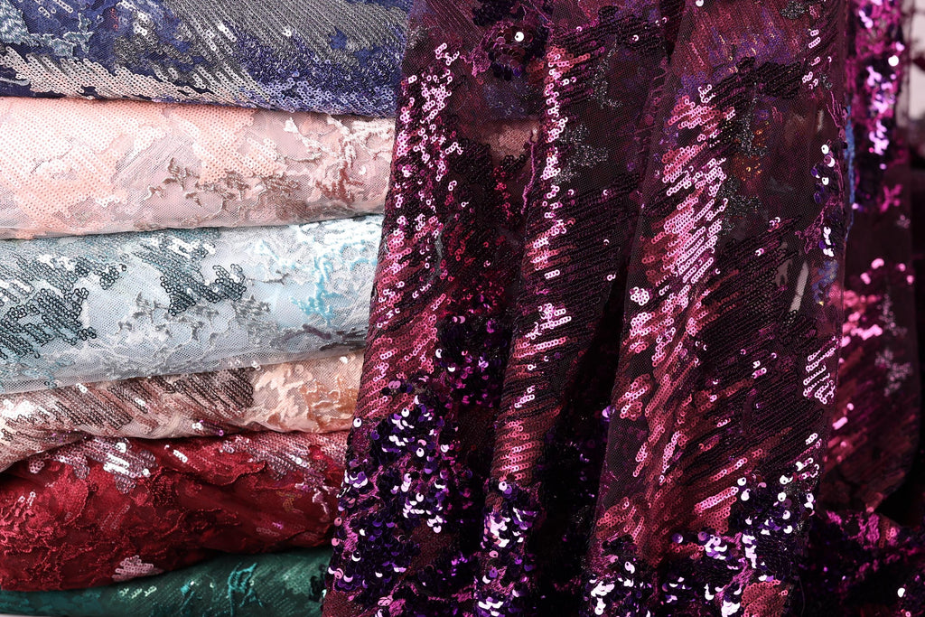 A close-up view of a pile of sequin fabric, showcasing the vibrant colors and patterns of the material.