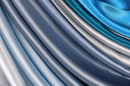 a close-up view of various shades of blue and silver fabric, creating a visually striking and textured composition.