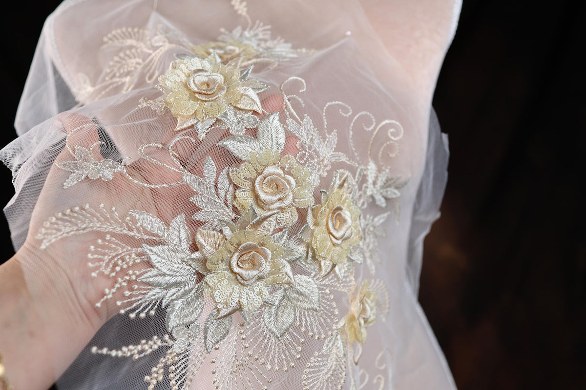 a close up of a person wearing a veil with flowers on it