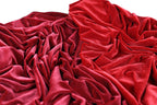 a close-up view of a crumpled red fabric, with its folds and creases creating a textured and visually interesting surface.
