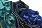 a close-up view of various textured fabrics, including blue and black materials, arranged together.