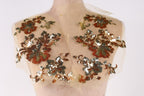 A mannequin with a beige dress and a sheer, floral-patterned fabric covering the upper body.