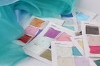 a collection of fabric swatches or color samples, each with a corresponding color label, likely used for design or fashion purposes.