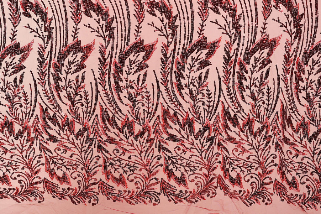 a close-up view of a fabric with a repeating pattern of red and black floral designs. The pattern consists of stylized leaves and flowers, creating a visually striking and intricate design. The fabric appears to be made of a light-colored material, which contrasts with the dark red and black colors of the floral pattern. The image does not contain any text or other discernible objects, and the focus is solely on the detailed floral design.