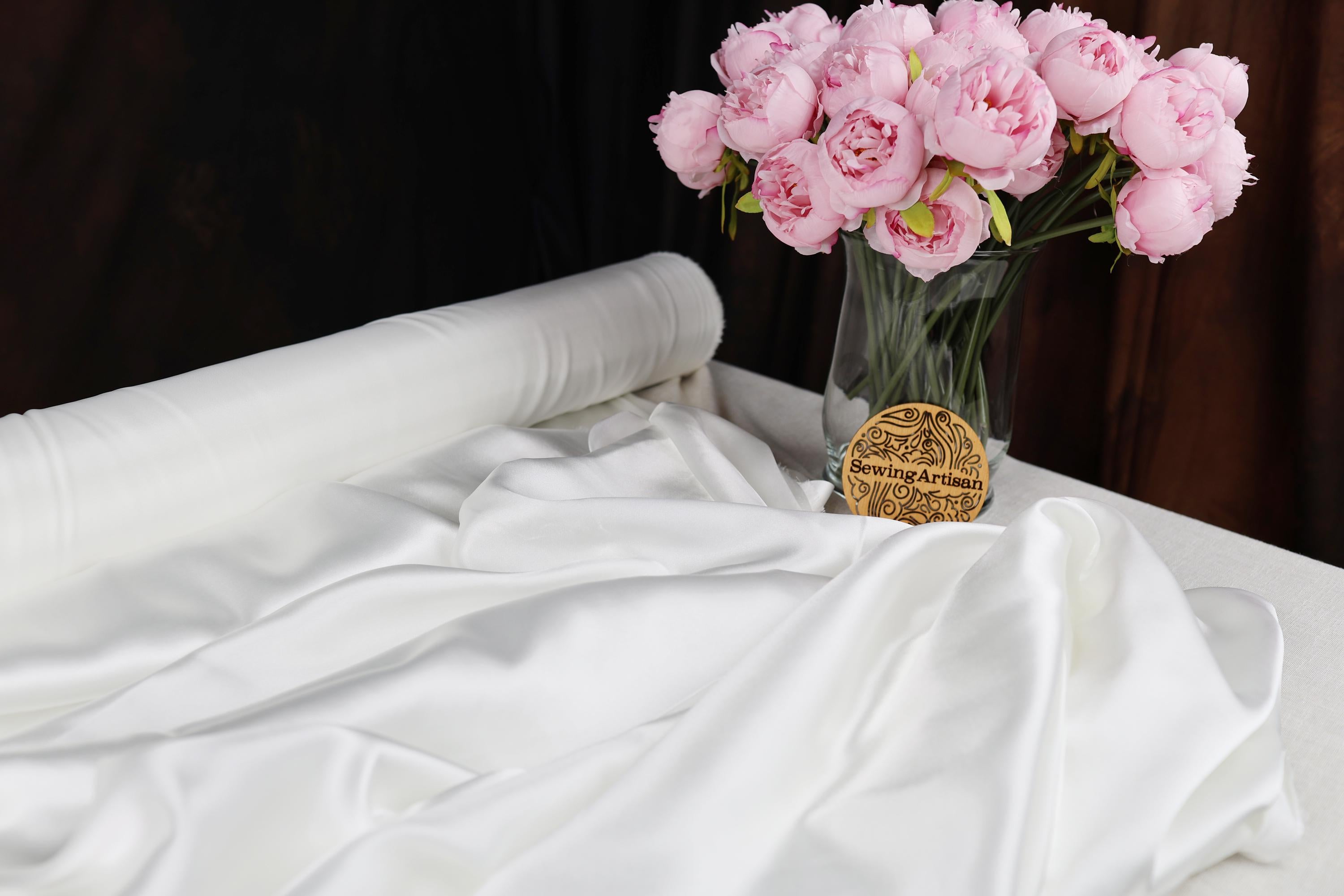 a vase filled with pink flowers sitting on top of a table