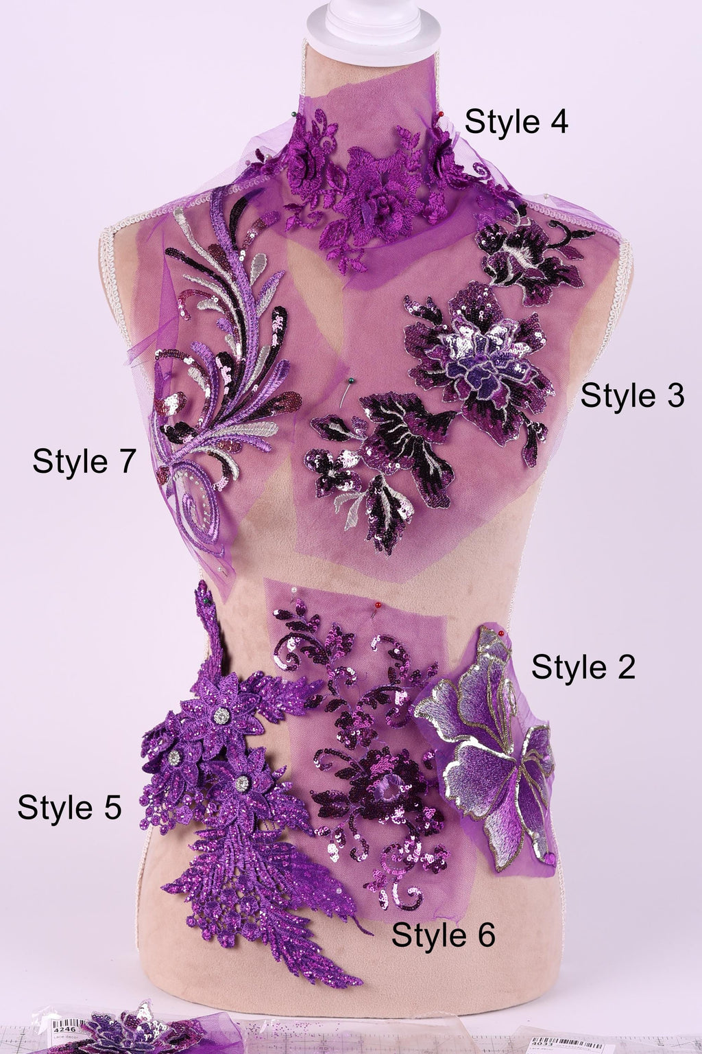 A mannequin with various purple and black floral and sequin designs on its body, including different styles such as Style 4, Style 5, Style 6, and Style 7.