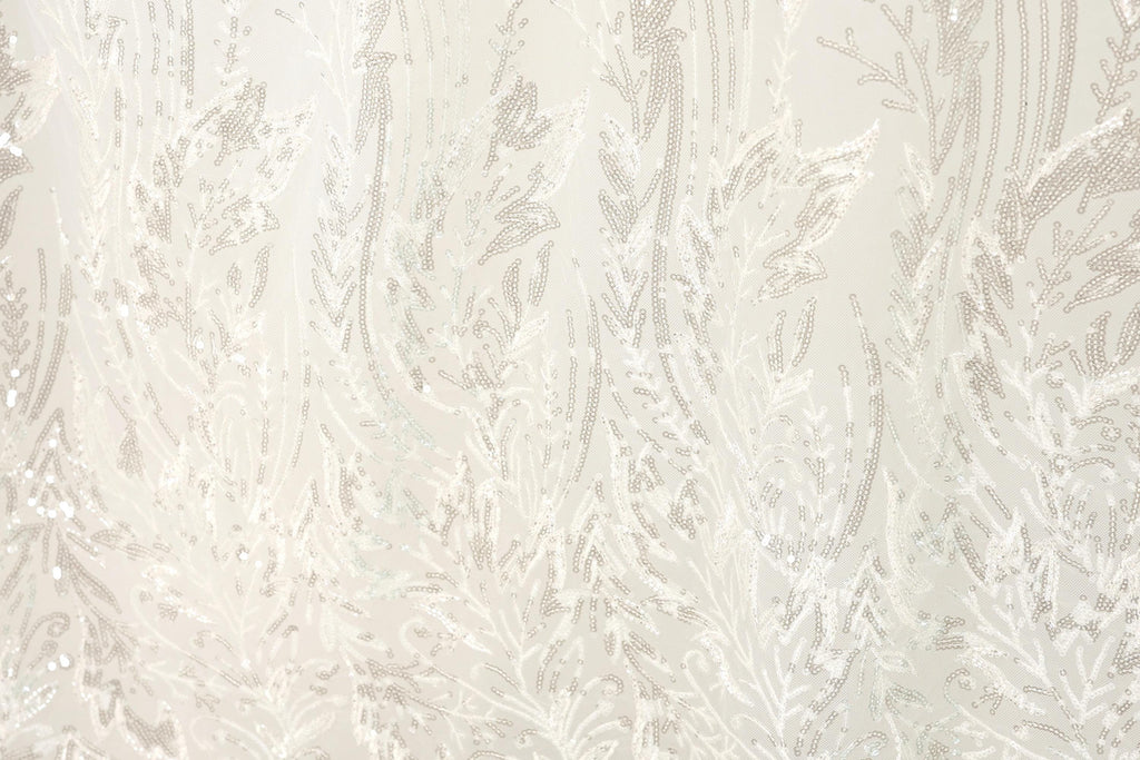 The image is a close-up of a fabric with a white and beige floral pattern, featuring a repeating design of leaves and branches.