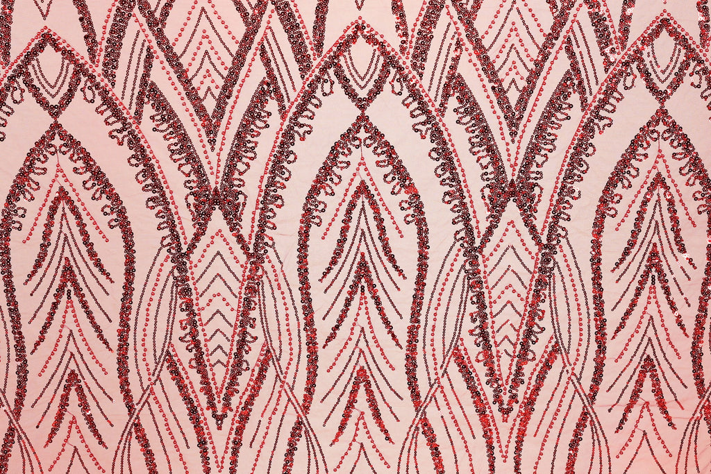 a close-up view of a fabric with a repeating pattern of red and black sequin designs. The pattern consists of various shapes and lines, creating a visually striking and intricate design.