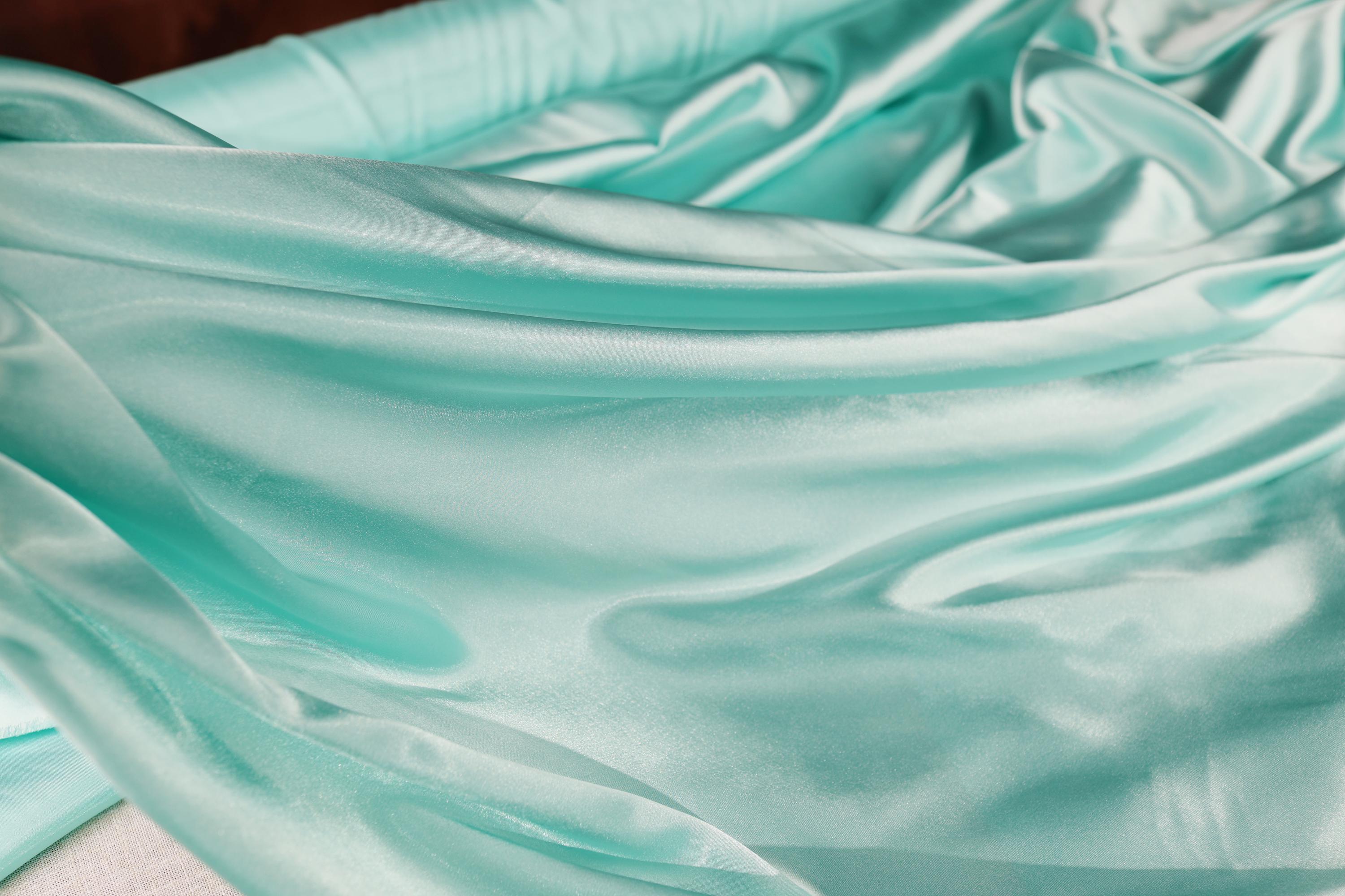 a close up of a blue satin material