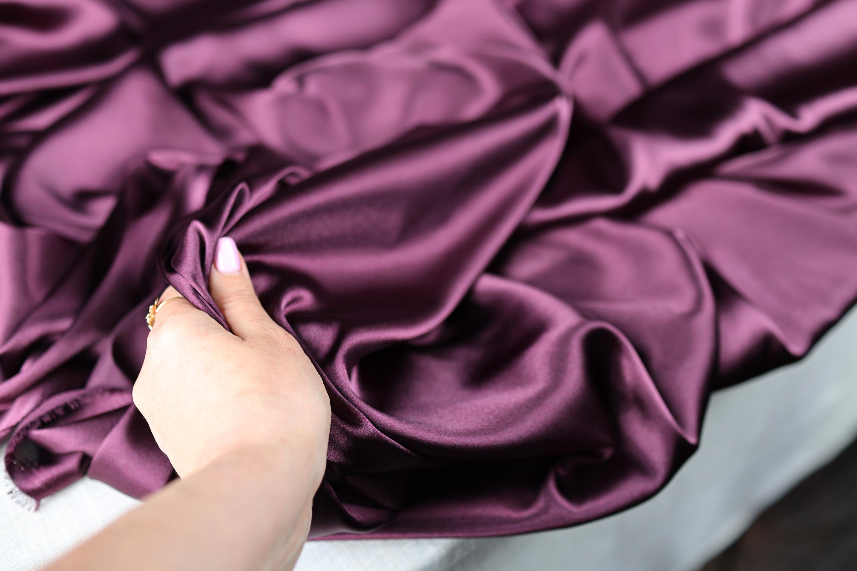a woman's hand on a purple cloth