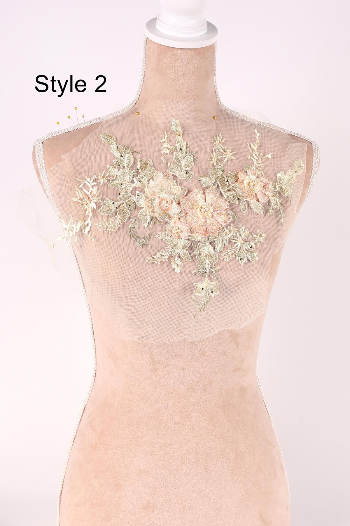 A mannequin wearing a dress with a floral pattern on the bust area.