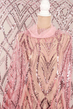 a mannequin wearing a pink sequin dress with a sheer overlay.