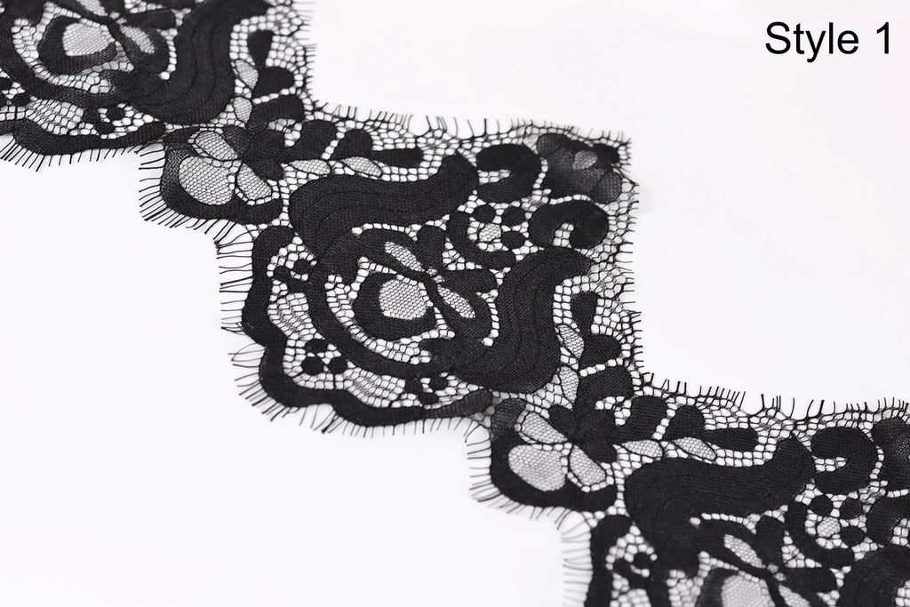 a close-up view of a black lace fabric with intricate floral patterns.
