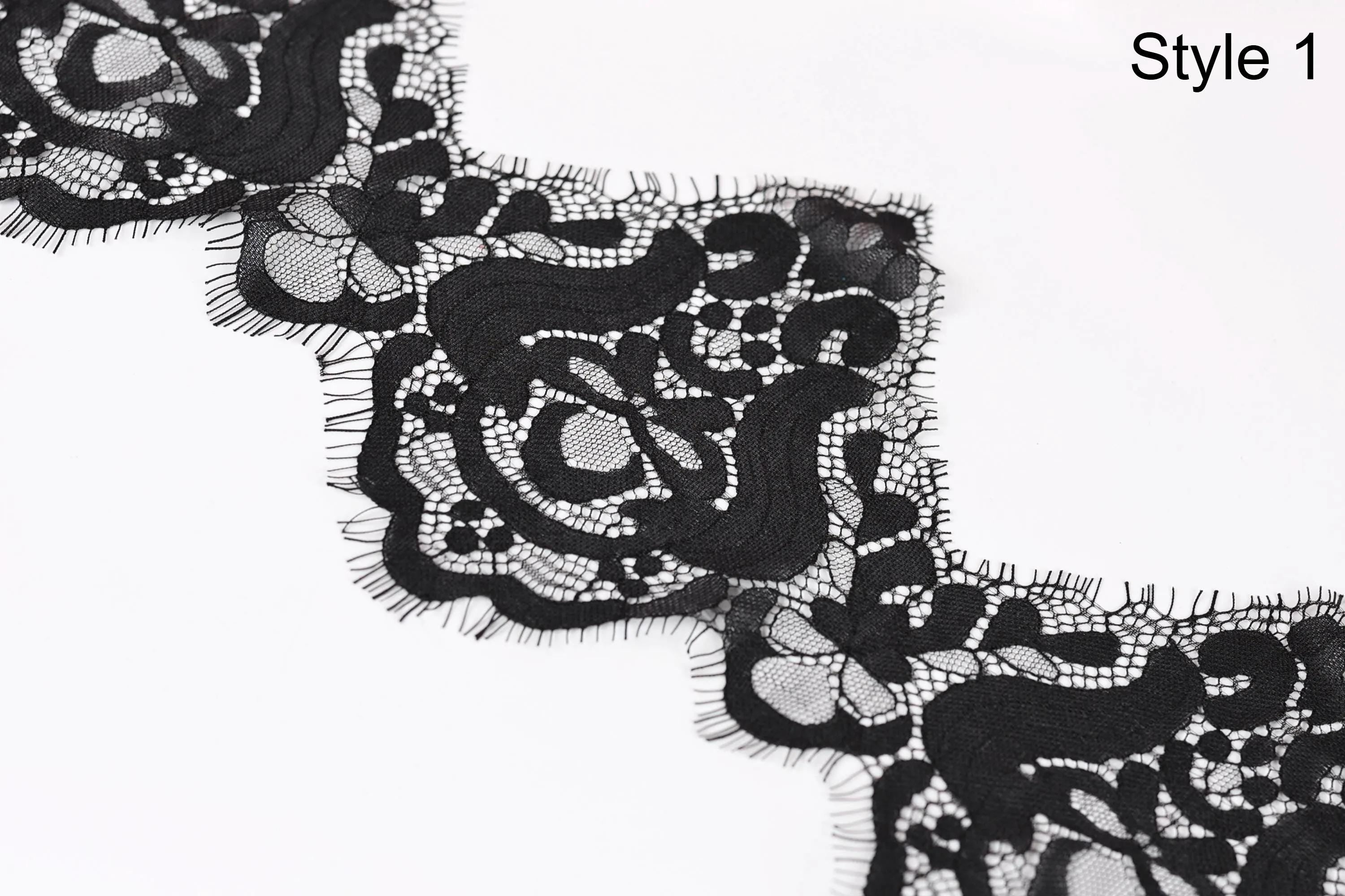 a close-up view of a black lace fabric with intricate floral patterns.