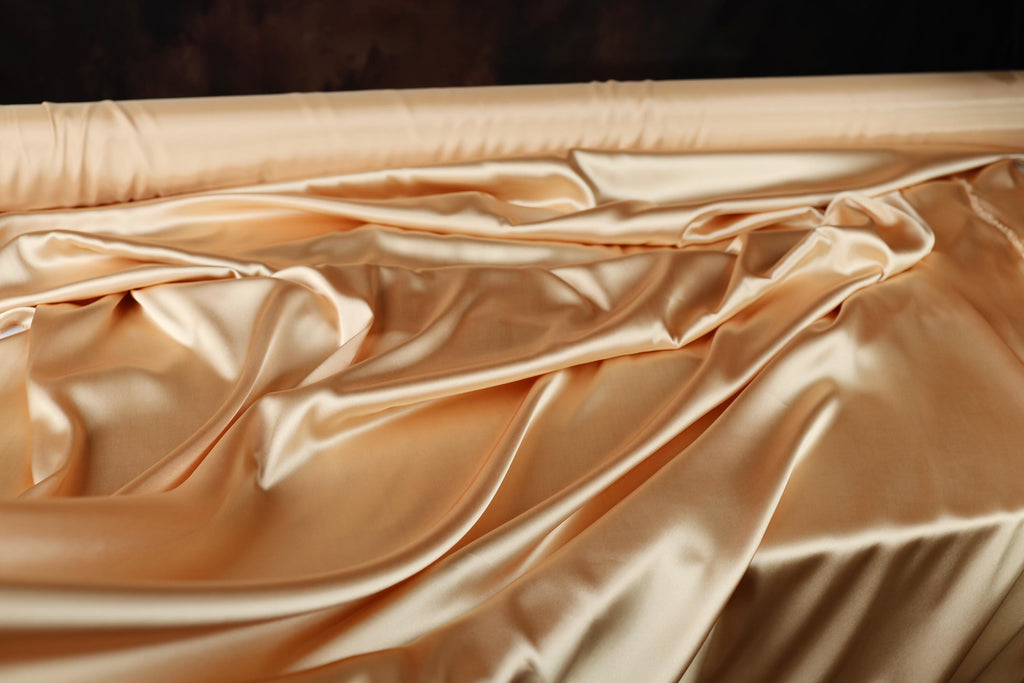 a close up of a bed with a sheet on top of it