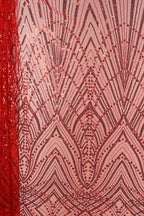 a close-up view of a fabric with a striking pattern of red and black sequins. The pattern is intricate and detailed, with a repeating design of intersecting lines and dots that create a visually captivating effect. The fabric appears to be a type of sheer material, with a sheer overlay that adds a delicate, airy quality to the overall design.