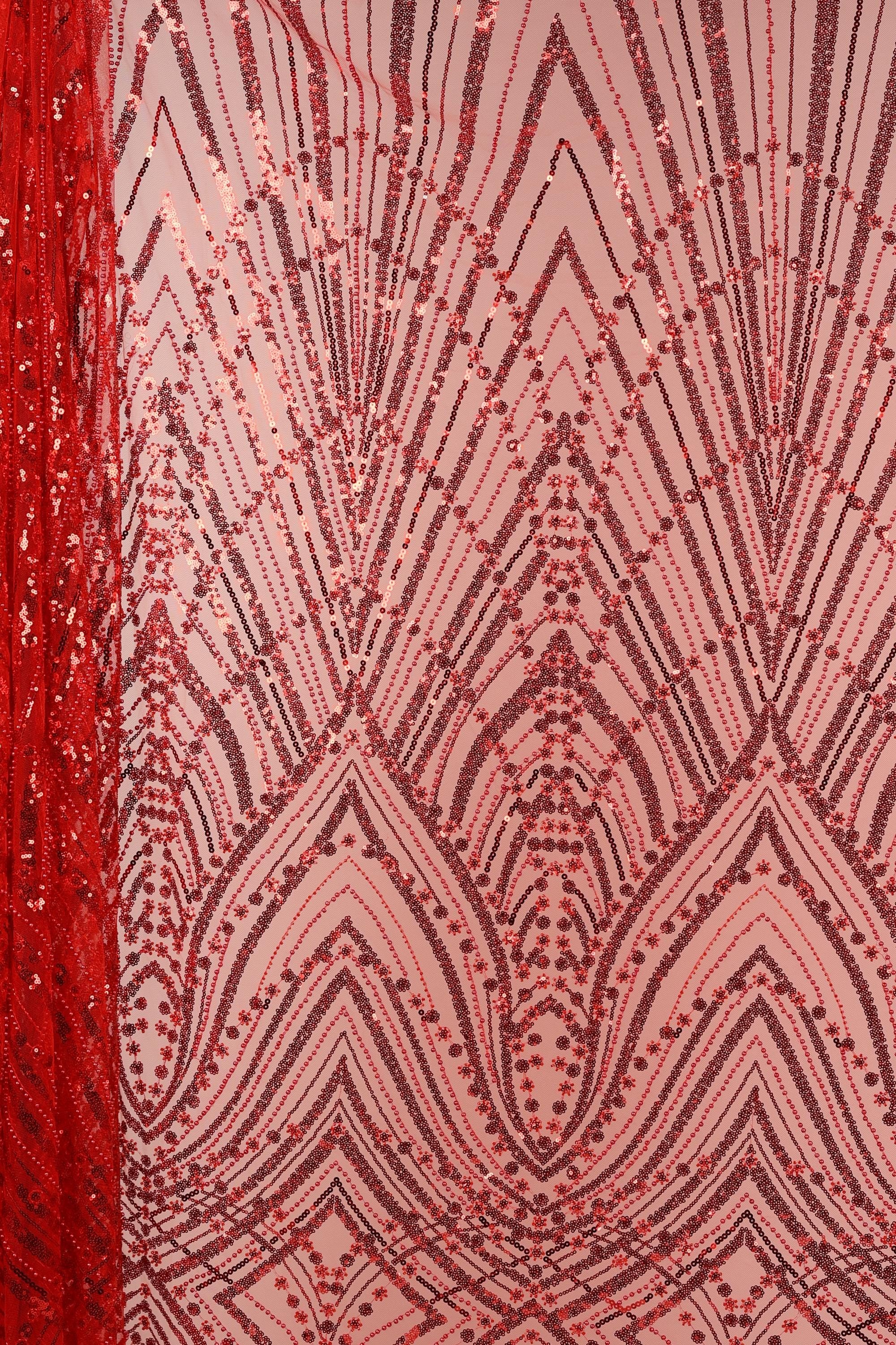a close-up view of a fabric with a striking pattern of red and black sequins. The pattern is intricate and detailed, with a repeating design of intersecting lines and dots that create a visually captivating effect. The fabric appears to be a type of sheer material, with a sheer overlay that adds a delicate, airy quality to the overall design.