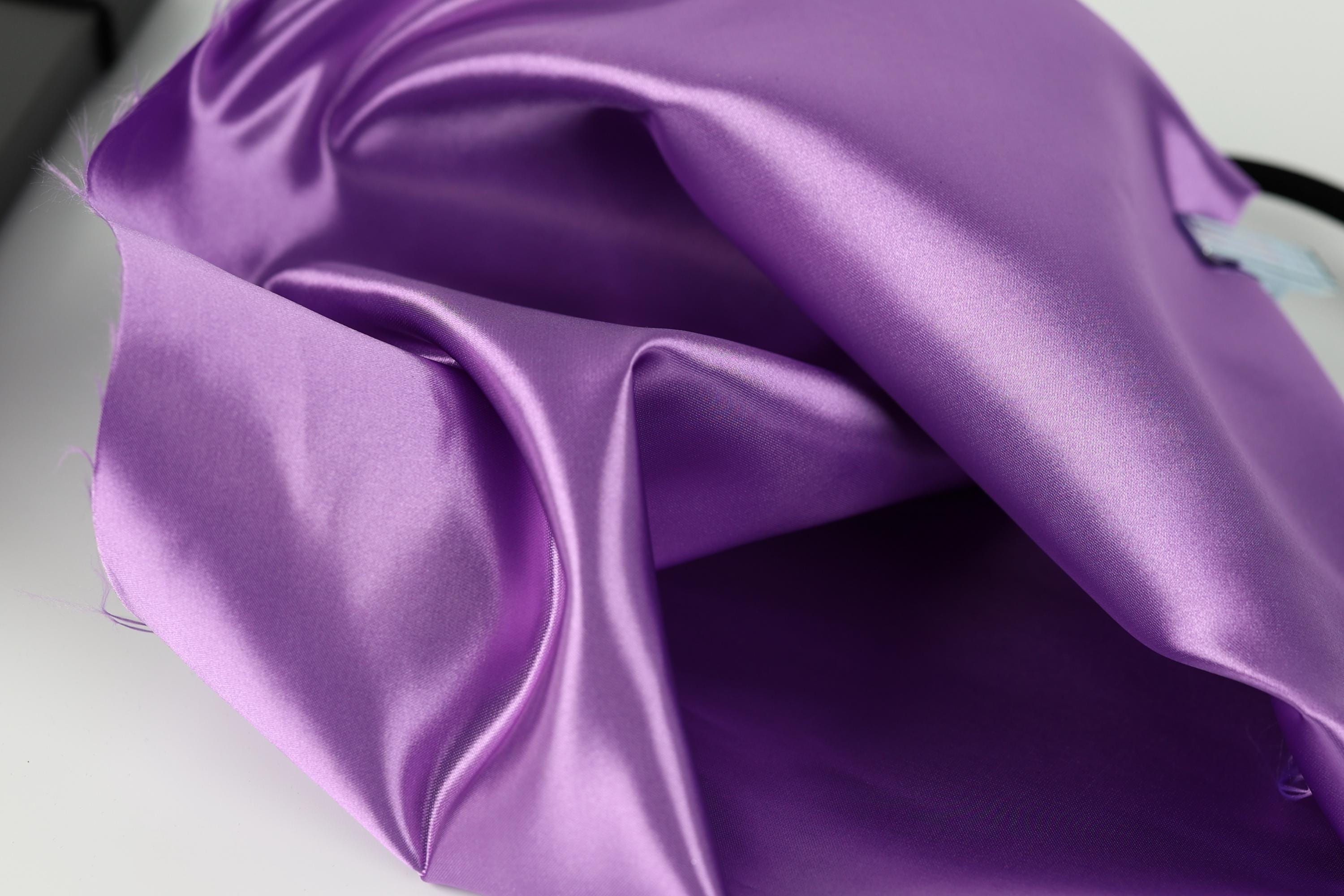 a close-up view of a shiny, purple satin fabric.