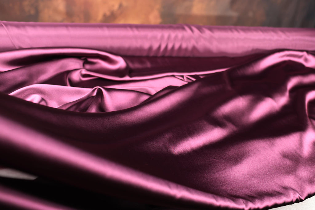 a close up of a pink satin material