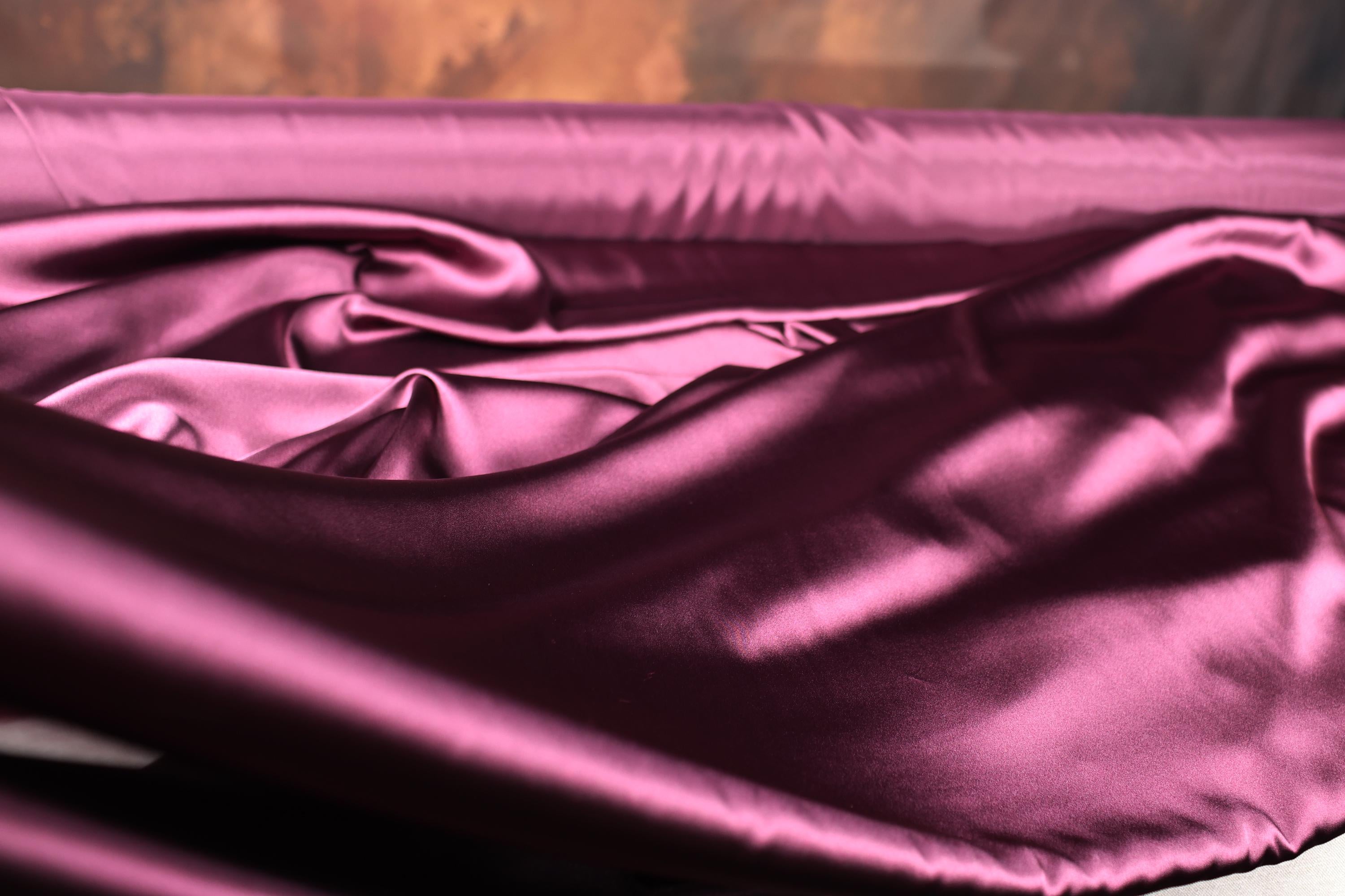 a close up of a pink satin material