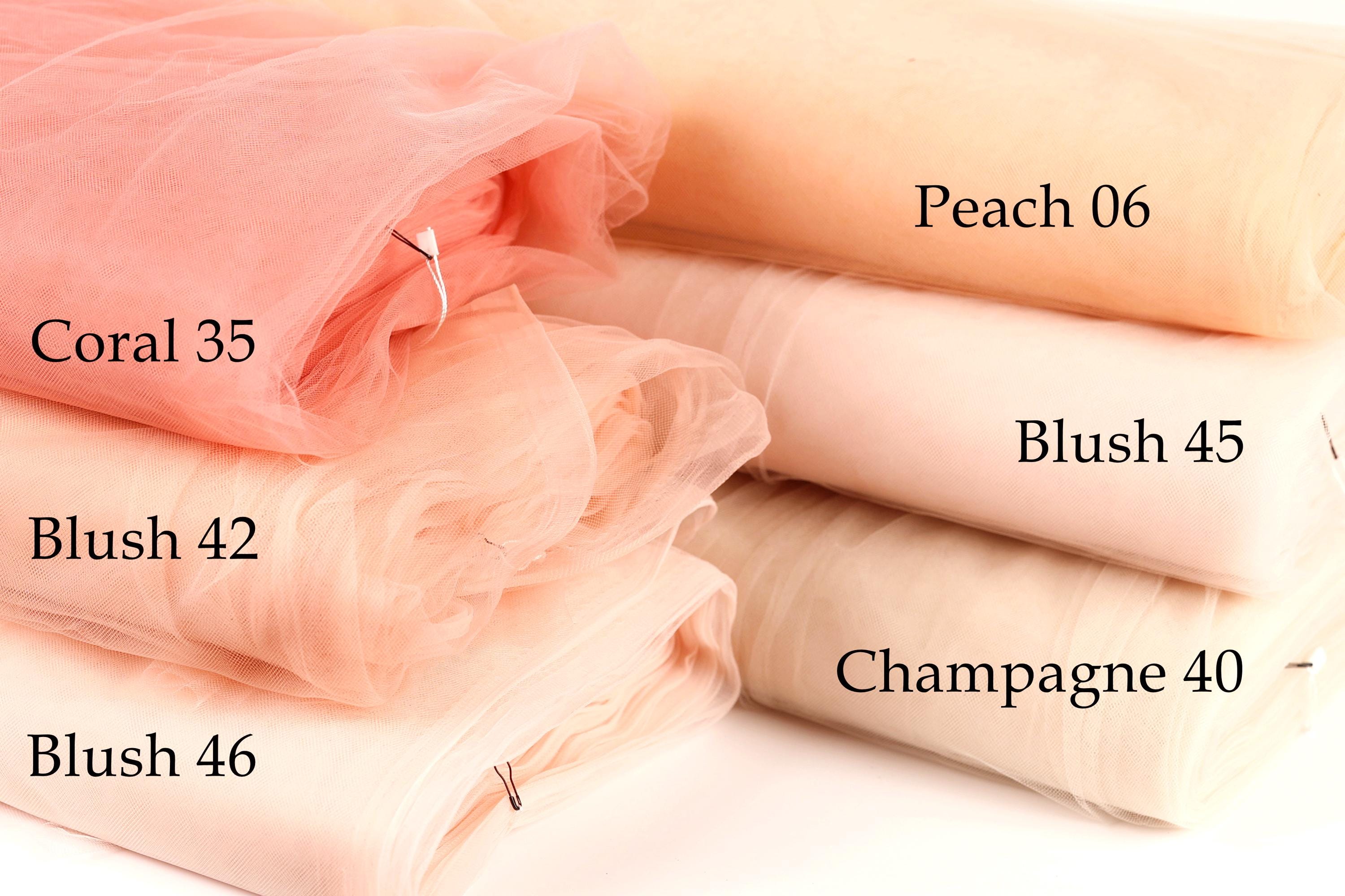 a collection of fabric swatches in various shades of peach, including coral, peach, and champagne.