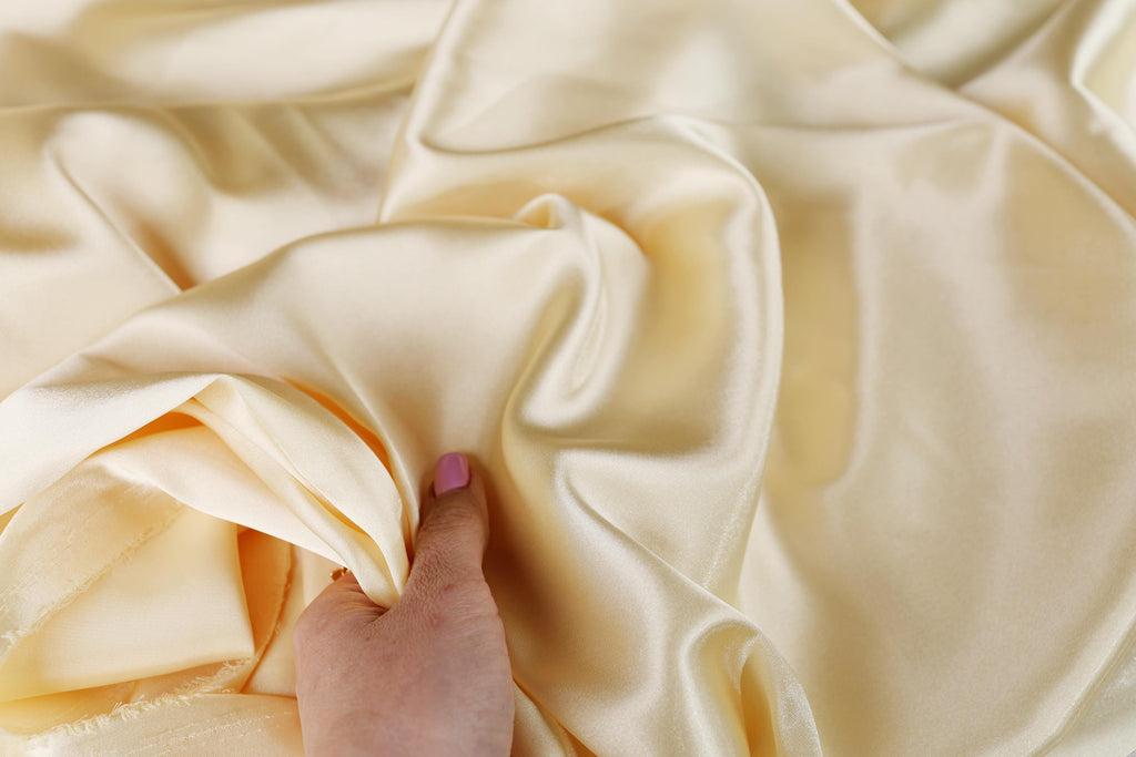 a person's hand on a white cloth