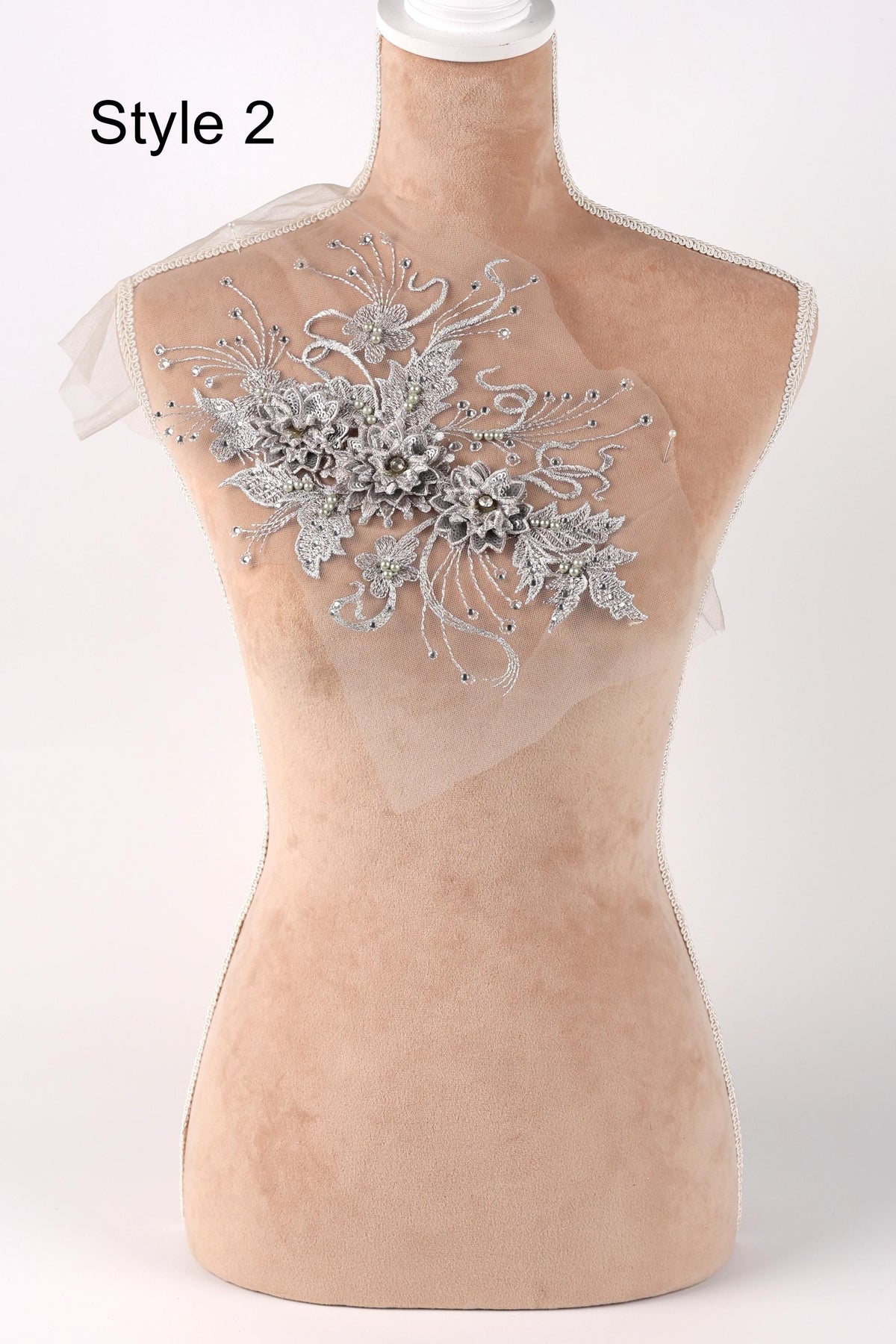 A mannequin with a decorative floral embroidery on its bust.