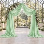 Light mint green chiffon draped on a round wedding arch